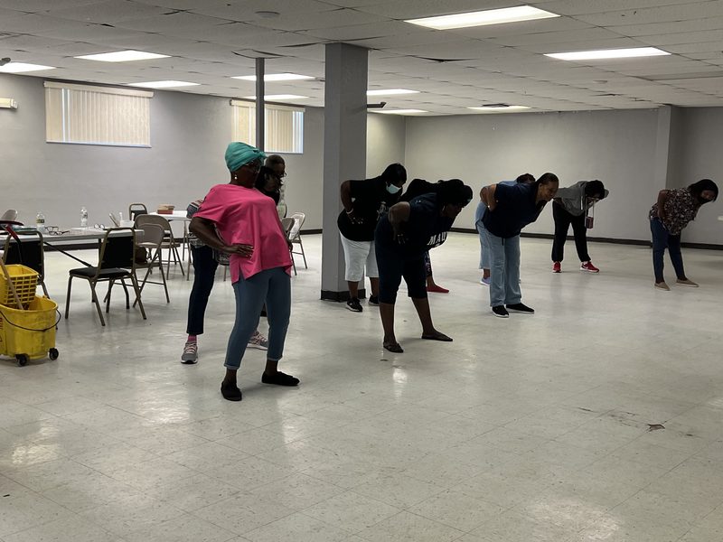 A standing group fitness class in progress